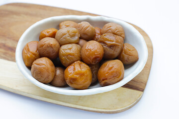 Pickled plums on white background.