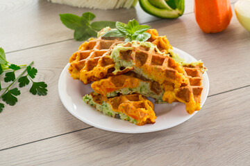 cooked two-color vegetable waffles made from cabbage and carrots.