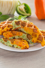 cooked two-color vegetable waffles made from cabbage and carrots.
