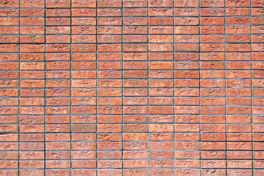 Brick wall laid in straight grid regular brickwork pattern