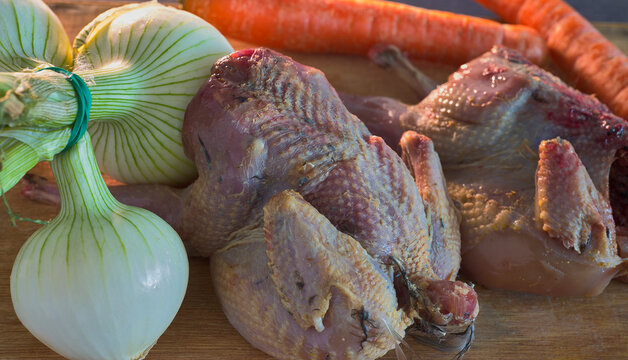 A couple of partridges, chives and carrots. Ingredients for a partridge recipe, also valid to make with quail