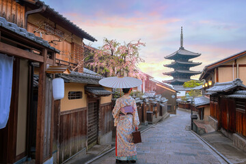 Young Japanese woman in traditional Kimono dress with Yasaka Pagoda at Hokanji temple in Kyoto,...