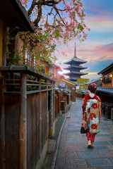 Young Japanese woman in traditional Kimono dress with Yasaka Pagoda at Hokanji temple in Kyoto,...