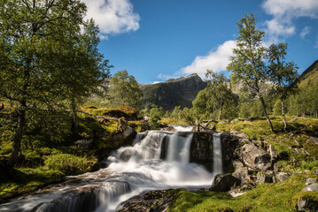 Fototapeta na wymiar Waterfall in a valley in western Norway. Summer.