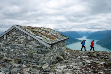 Hiking on a mountain in western Norway, passing a stone cabin. Magnificent view.