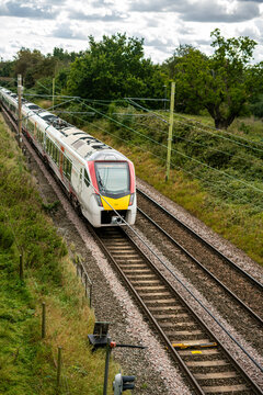 Greater Anglia train passing through a forest in England