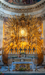 Golden luxurious altar inside catholic cathedral in Rome