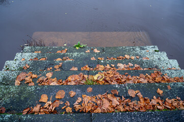 Old stone stairs lead down to Black river Orebro
