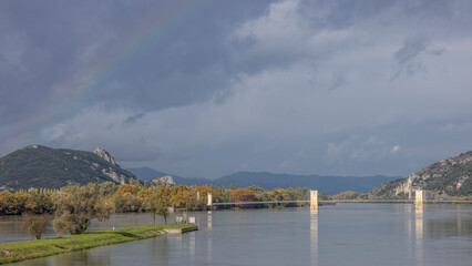 Fototapeta na wymiar Beginning of a rainbow over the Pont du Robinet in Donzere, France