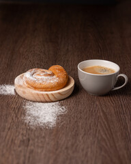 Breakfast with ensaimada and cup of coffee