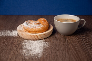 Breakfast with ensaimada and cup of coffee