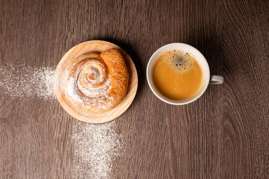 Breakfast with ensaimada and cup of coffee