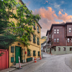 Fototapeta na wymiar Colorful residential buildings painted in vibrant colors, at an alleys of Kuzguncuk neighborhood, Uskudar district, Istanbul, Turkey before sunset