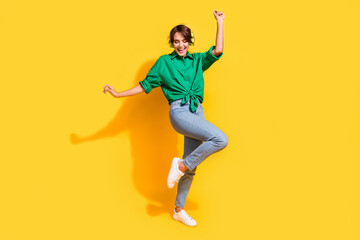 Fototapeta na wymiar Full length photo of pretty cheerful girl dressed green shirt headphones dancing having fun isolated yellow color background