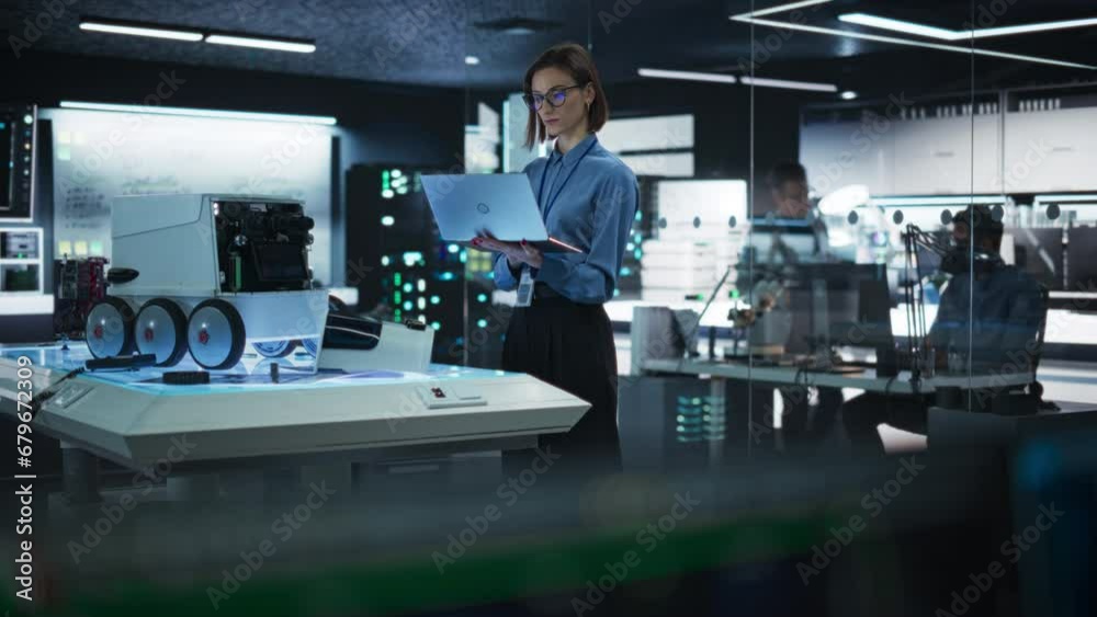 Aufkleber Portrait of a Female Programmer Using Laptop Computer to Write Code For a Remotely Controlled Robot. Elegant Woman Working in High-tech Lab, Gathering Data in a Advanced-Technology Project