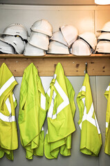 yellow neon safety jackets and white helmets for construction visitors