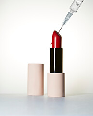 Red Lipstick and syringe with hyaluronic acid