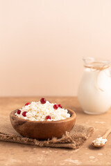 Homemade cottage cheese with berries and jug of milk. Dairy products.