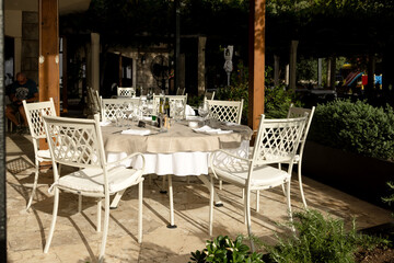 A set table on the summer veranda of the restaurant
