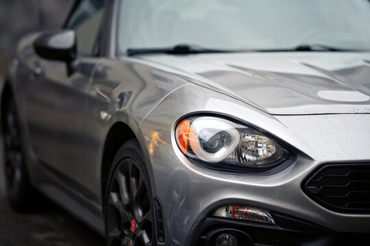 Minsk, Belarus. Nov 12, 2023. Fiat 124 Spider Abarth parked on parking lot. Roadster headlight, front view.