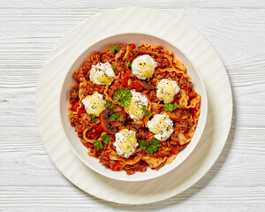 Lasagnette with ground beef in bowl, top view