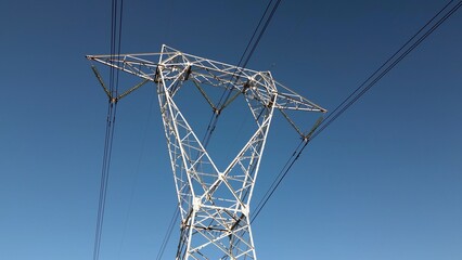 High voltage pylon for the transport of electricity and houses with solar panels close to Milan  in...