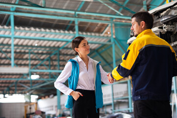 Insurance claim Inspector Inspect damage car caused by car crash on the road with customer. Car insurance agent examining car in garage. Motor insurance. Successful businessmen handshaking good deal