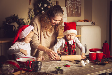 Mom and children are preparing cookies in the kitchen.