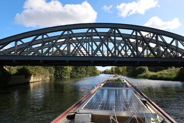 Railway bridge over river and narrowboat