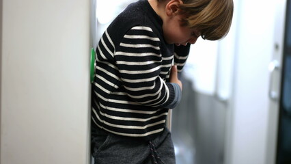 Solo Child Traveler Engaged in Play While on Train Ride. Small boy Passenger Playing Alone in Train Holding Metal Bar