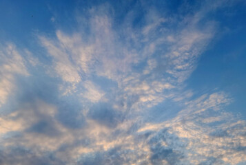 Clouds just after a sunrise time in the blue sky in the autumn