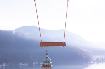 Empty Swing with Mountain View and Sunlight over Lake Lugano in Morcote, Ticino in Switzerland.