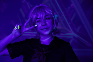 blonde anime woman with fluorescent manicure winking and showing victory sign in blue neon light