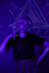 Naklejka na ściany i meble blonde woman in school uniform with hand on hip showing victory sign in blue neon light, anime style