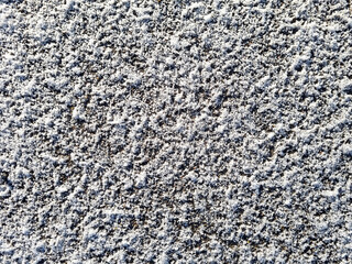The texture of the snow on the ground or on the asphalt in winter. Winter background for design