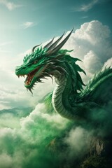 A big beautiful green dragon with a mouth on top of a high mountain in fog against the sky with clouds.
