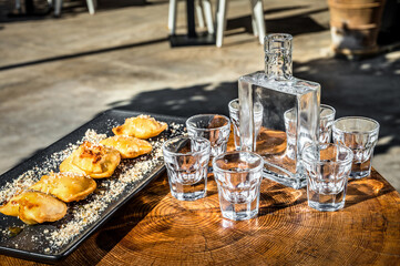 Close-Up of Mizithra Sweet Cheese Pies Drizzled with Honey, Paired with Traditional Raki.  Ideal for culinary projects, food blogs, or any design endeavor seeking to showcase retan gastronomy