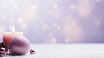  a candle that is sitting next to a christmas ornament with a pine cone on the top of it.