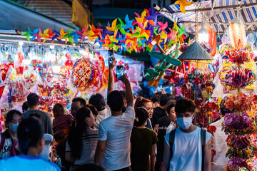 People visit and buy colorful traditional lanterns hanging on Luong Nhu Hoc Street in Vietnam