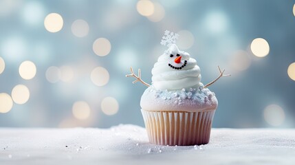  a frosted cupcake with a frosted snowman on top of it, sitting in the middle of a pile of snow.