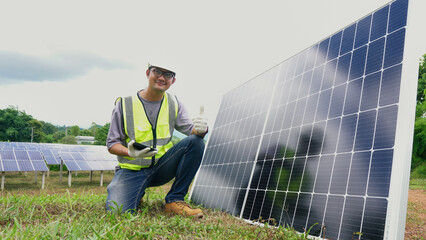 Asian man engineer using digital tablet maintaining solar cell panels  working outdoor on ecological solar farm construction.