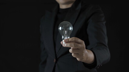 business. businessman hold lightbulb in that has cog and idea.
