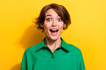 Closeup portrait of attractive young business lady look open mouth excited news wearing green shirt isolated yellow color background