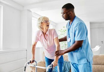 nurse doctor senior care caregiver help walker assistence retirement home nursing elderly woman black man hospital clinic home disability disabled - obrazy, fototapety, plakaty