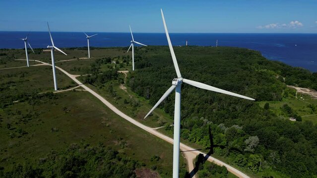 Offshore wind turbines in the seashore. Wind power turbines generating clean renewable energy for sustainable development. Coastal windmill Turbine farm in Paldiski, Estonia. 