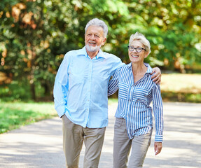 woman man senior couple happy retirement together elderly active vitality park fun smiling love old nature wife happiness mature walking holding hands