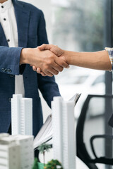 Close up shake hands, Considering buying a home, investing in real estate. Broker signs a sales agreement. agent, lease agreement, successful deal
