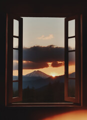tramonto su un paesaggio di montagne e colline visto attraverso una finestra