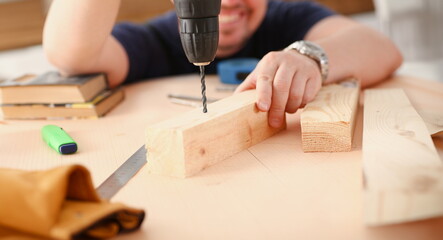 Arms of worker using electric drill closeup. Manual job DIY inspiration improvement job fix shop...