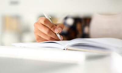 Arm of black woman write story in notebook preparing for college